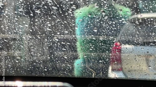Point of view shot from inside a car passing through an automatic car wash.