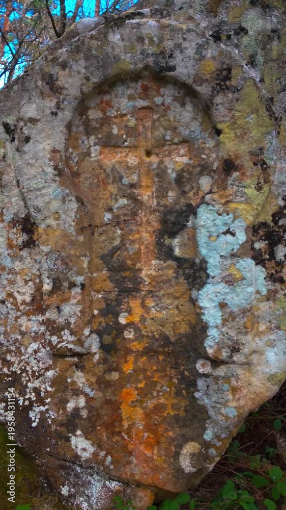 Vertical video of a cross pattée centered in a horseshoe arch at Cueva ...