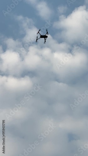 The footage shows a camera drone flying against the clear blue sky.