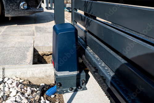 Automatic sliding gate drive motor and gear rack assembly