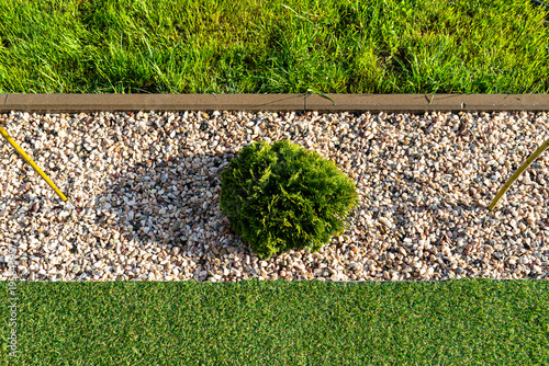 Garden landscaping with gravel bed and green grass