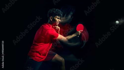 Table tennis player hitting powerful shot with strong motion effect in dark studio. Concept of physical strength expression, explosive energy, force application and high intensity sports performance.