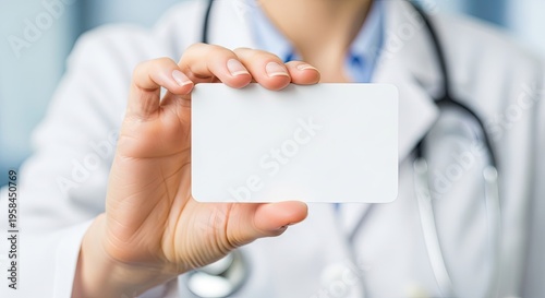 A healthcare professional holds a blank white medical card in their hand. The doctor is wearing a white coat and stethoscope.
