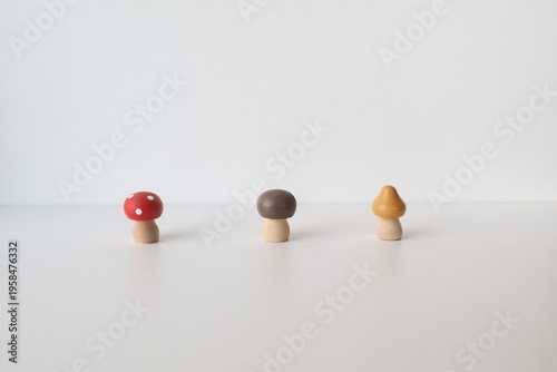 Photo taken in Poland, Krakow, March. Small wooden toys in the shape of different mushrooms for children, cribs with colorful caps, wooden toys.