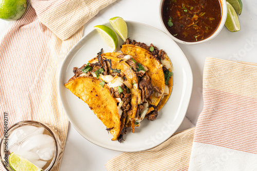 Birria tacos. Mexican food made with beef and a dipping sauce