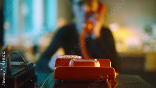 Female call center worker reaching for a retro old school landline rotary phone to make a call and dialing a number. Selective focus