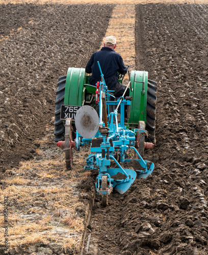 Bratton, Wiltshire, UK,22nd March 2026 - rear view of a plough and vintage tractor ploughing a furrow in a ploughing match