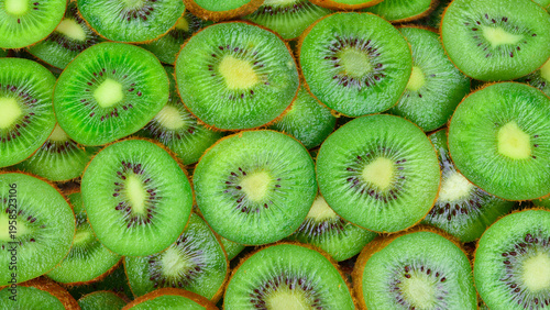 Top view of heap of sliced kiwi as textured background.