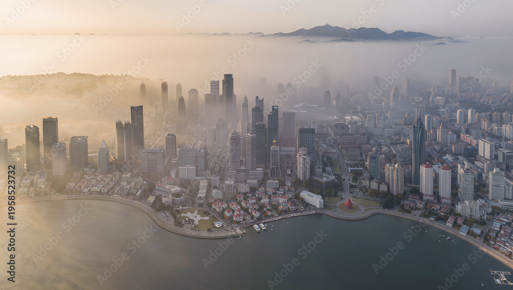 Fototapeta premium Aerial View of Coastal City Skyline Enveloped in Morning Mist