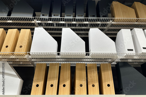 Rows of shelves with colorful folders, binders and desk organizers in stationery store, office and school supplies display, retail interior with neatly arranged document storage products