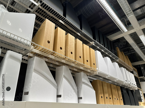 Rows of shelves with colorful folders, binders and desk organizers in stationery store, office and school supplies display, retail interior with neatly arranged document storage products