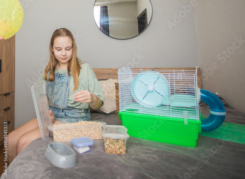 A woman holds a yellow ball while a girl organizes bedding insid