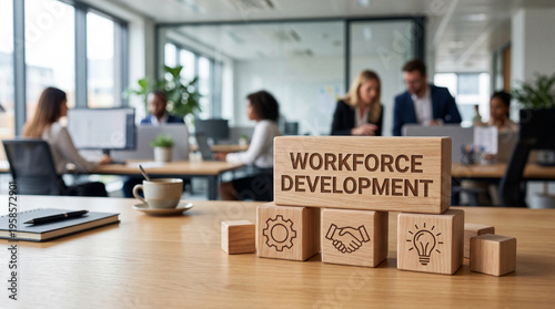Workforce development concept illustrated with wooden blocks and business icons on an office desk symbolizing strategic growth and human resource training in a modern corporate setting