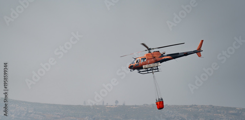 Helicopter in Action with Firefighting Bucket