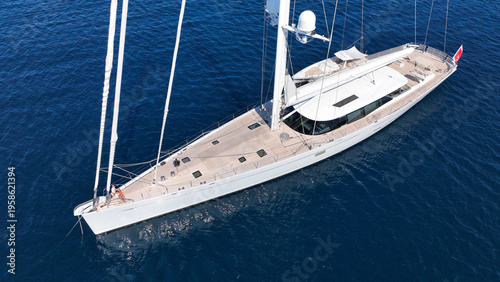 Aerial drone photo of beautiful sail boat anchored in deep blue Aegean Sea