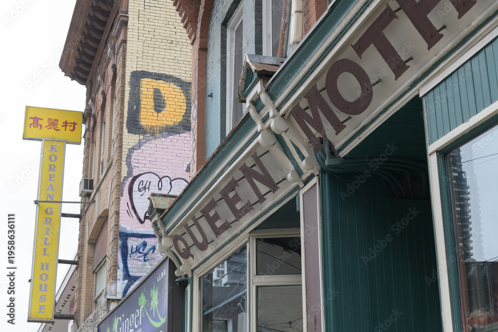 Fototapeta premium exterior perspective view of Queen Mother Cafe, a restaurant, located at 208 Queen St W, Toronto