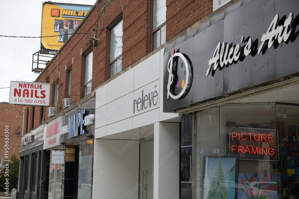 Fototapeta premium shops on Bayview Av, East York, Toronto: incl Relevé Clothing, a women's clothing store and Alice's Art Studio