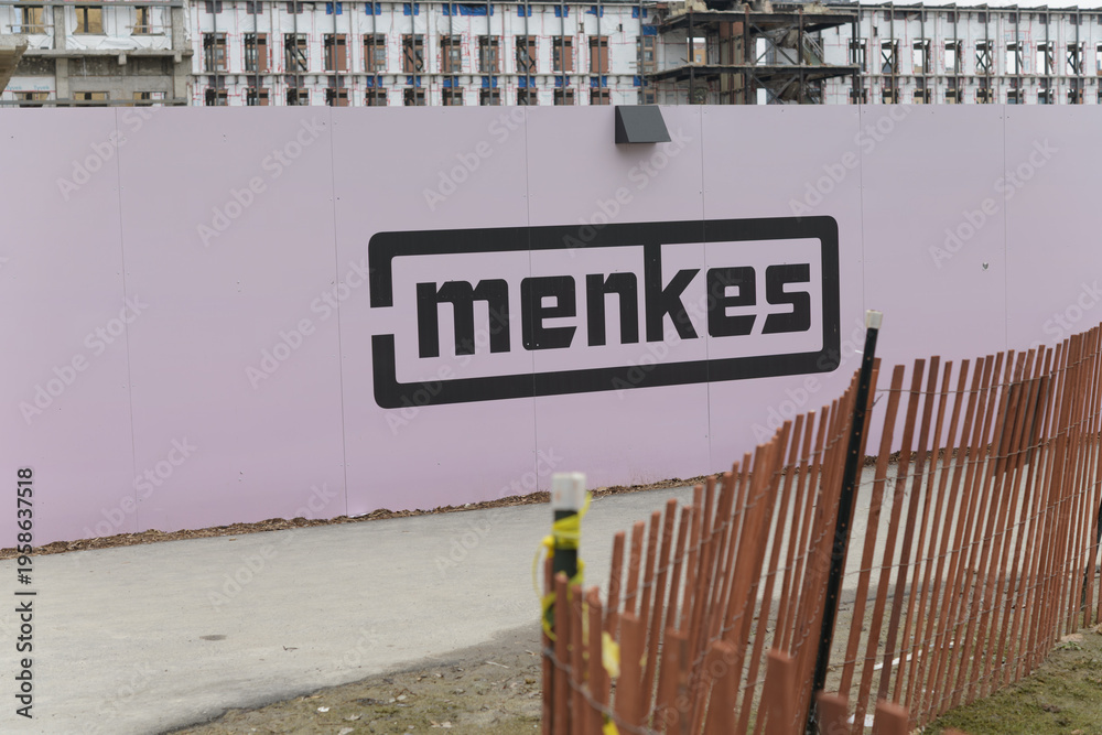 Fototapeta premium logo sign of Menkes Developments Ltd, a prominent private real estate developer, at 50 Queens Quay East Park, Toronto