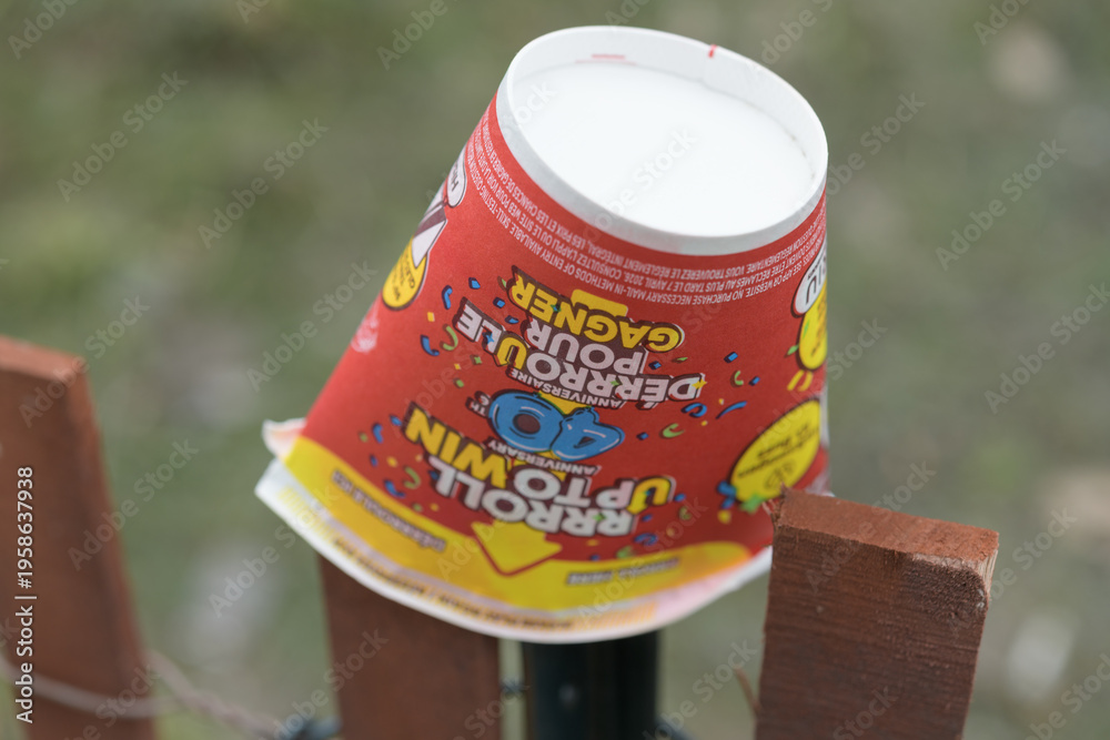 Fototapeta premium squashed, upside-down discarded Tim Hortons beverage cup featuring