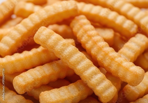 A pile of crinkle cut french fries on a table