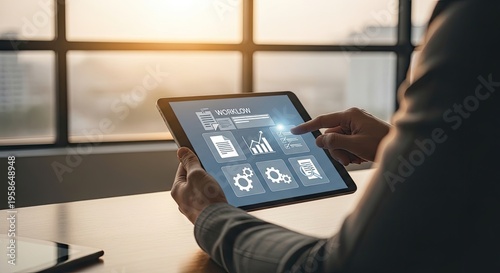 Business person using tablet displaying workflow icons and progress charts