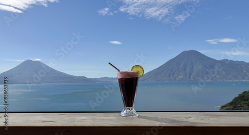 Wallpaper Mural Beverage with lime garnish set against a scenic lake atitlan and volcano backdrop, relaxation and travel lifestyle smoothie Torontodigital.ca