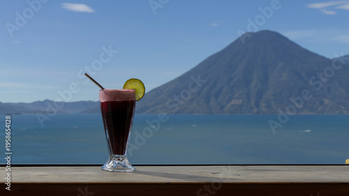 Wallpaper Mural Beverage with lime garnish set against a scenic lake atitlan and volcano backdrop, relaxation and travel lifestyle smoothie Torontodigital.ca