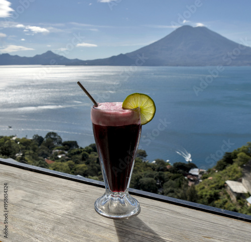 Wallpaper Mural Beverage with lime garnish set against a scenic lake atitlan and volcano backdrop, relaxation and travel lifestyle smoothie Torontodigital.ca
