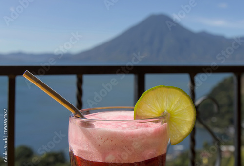 Wallpaper Mural Beverage with lime garnish set against a scenic lake atitlan and volcano backdrop, relaxation and travel lifestyle smoothie Torontodigital.ca