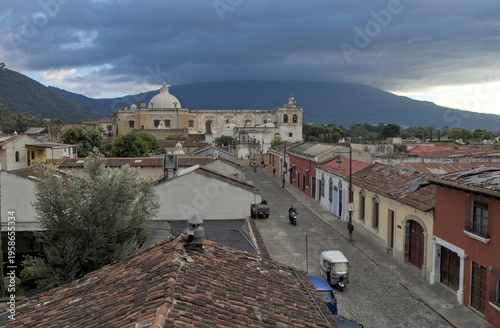 Wallpaper Mural Wide view of rooftops, streets, and distant church dome under a dramatic sky, antigua guatemala historic urban landscape. Torontodigital.ca