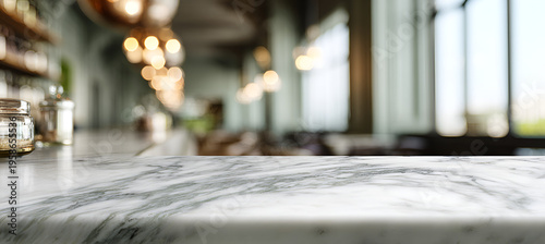 A close-up view of a marble countertop with blurred background of a dimly lit restaurant featuring a bar area