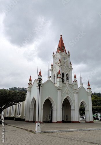 Wallpaper Mural Santuario de San Felipe de Jesús white neo-gothic church with pointed arches, red accents under cloudy sky, historic religious architecture design. Torontodigital.ca