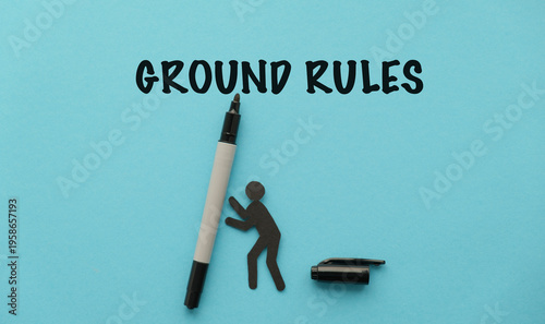 Ground Rules Concept: Handwritten Text on Blue Background with Stick Figure and Marker