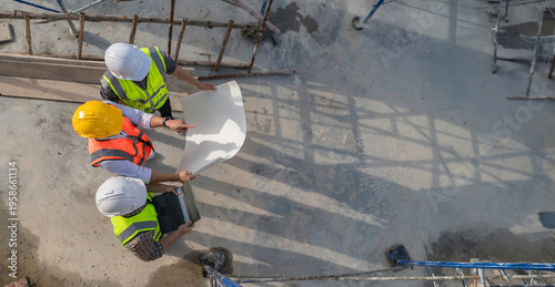Photos Three Asian engineer working at site of a large building project,Work overtime a