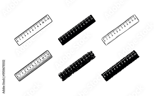 Five rulers lie scattered across a plain white surface