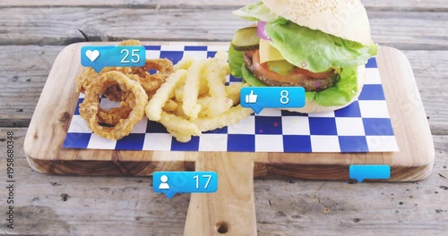 Camera lifting revealing board with burger, fries and rings, bubbles rising, showing engagement