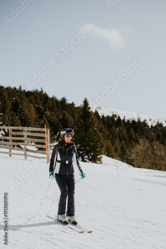 Woman skis on snowy mountai...