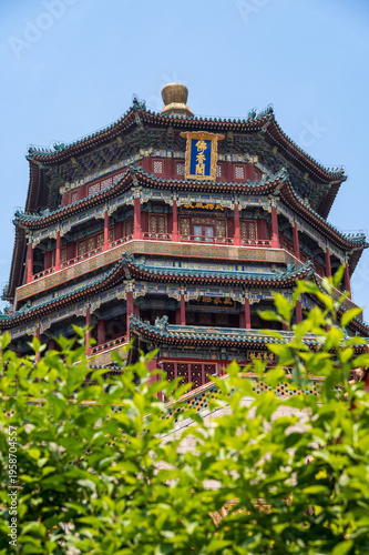 The majestic multi-tiered Tower of Buddhist Incense, showcasing its intricate colorful eaves and traditional architecture against a clear blue sky at the Summer Palace in Beijing, China - 27 May 2025