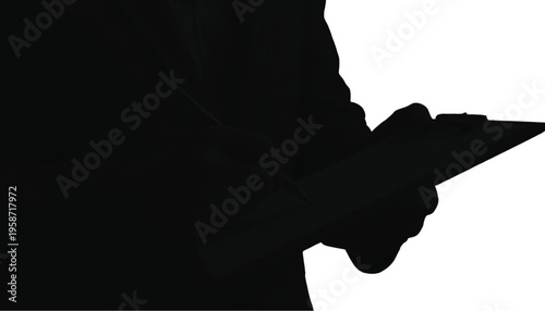 Close-up silhouette view of a person's hand holding a modern digital tablet device in the foreground.
