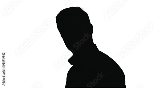 Close up silhouette portrait of a man's head and shoulders looking slightly down and away.