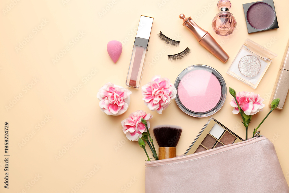Naklejka premium Different makeup products and beautiful flowers on beige background, flat lay. Space for text