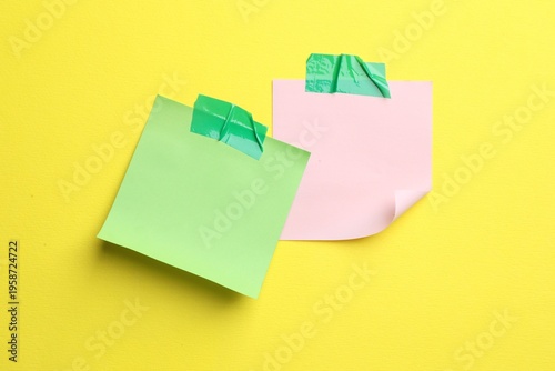 Reminder. Sticky notes on yellow background, top view