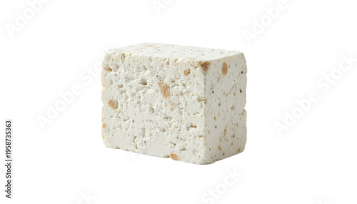 A block of white cheese with brown spots on a black background