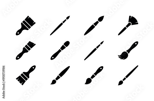 Collection of diverse black paint brushes and art tools on a white background