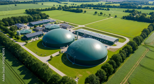Aerial view of biogas plant with green domes in countryside