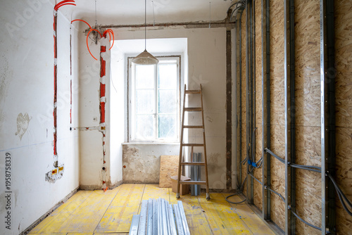 Bild auf Leinwand Interior renovation room with exposed wiring channels, unfinished walls and natu