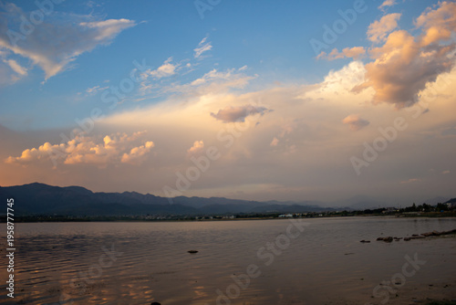 Natural Landscape with Trees and Water Under Dramatic Sky Background