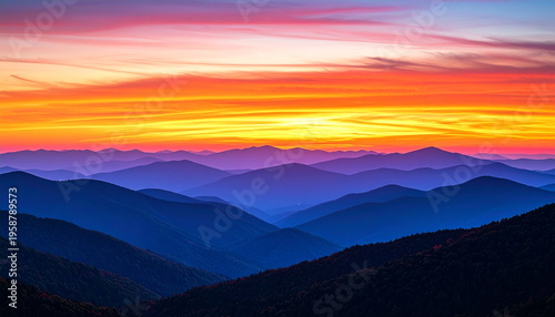 A breathtaking panoramic view of a mountain range at sunset, featuring multiple layers