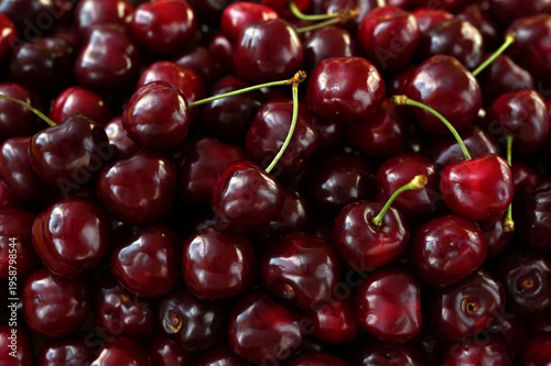 Full frame close-up of ripe dark red cherries texture