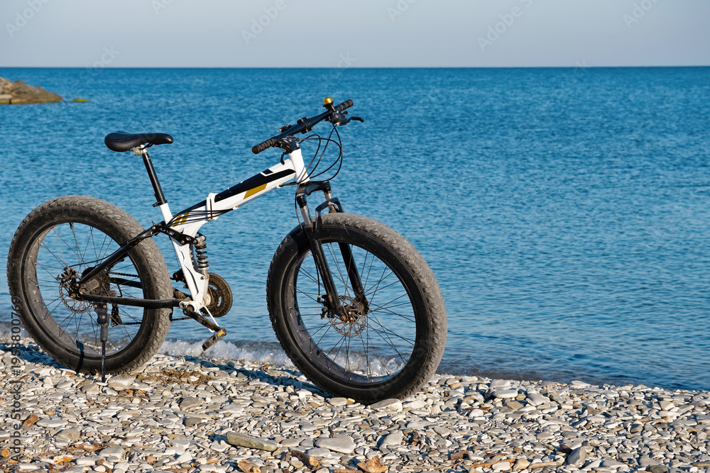 Fototapeta premium Parked on the beach bike waiting for the continuation